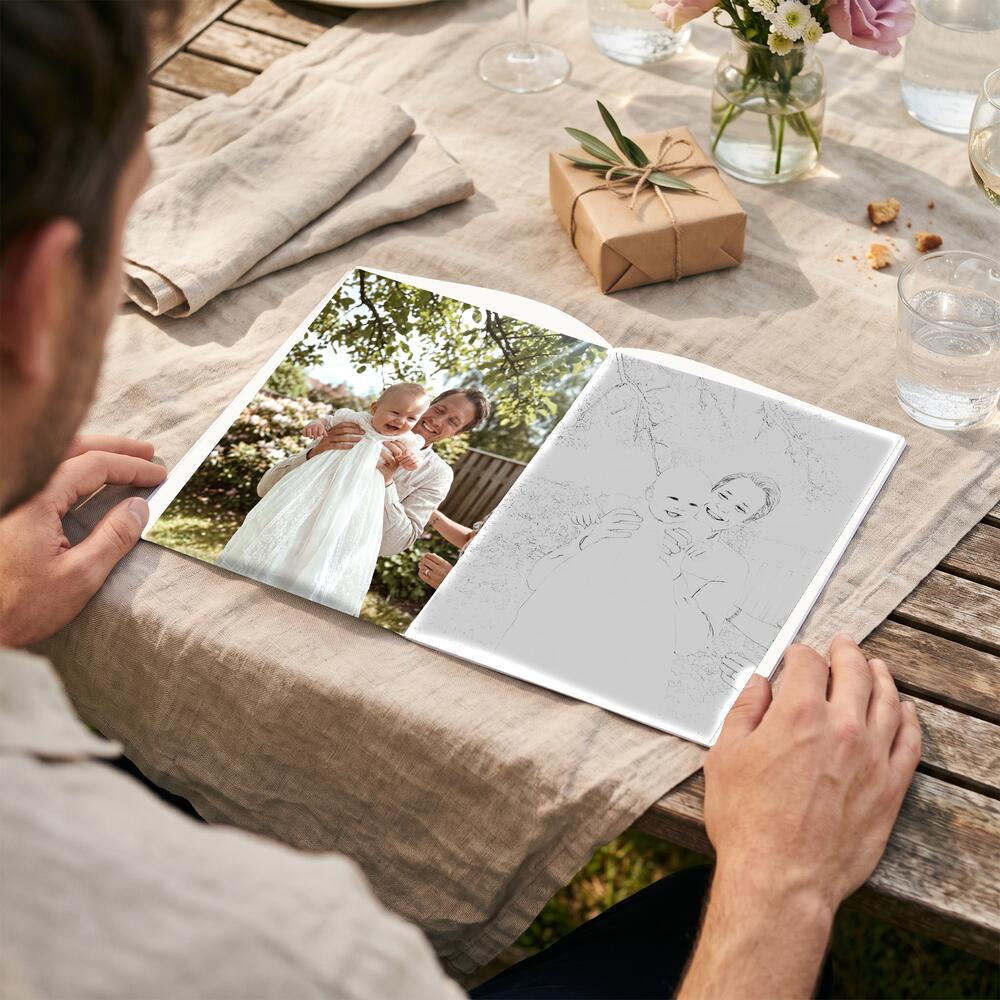A photo on the left page and the same moment as a colouring page on the right.
