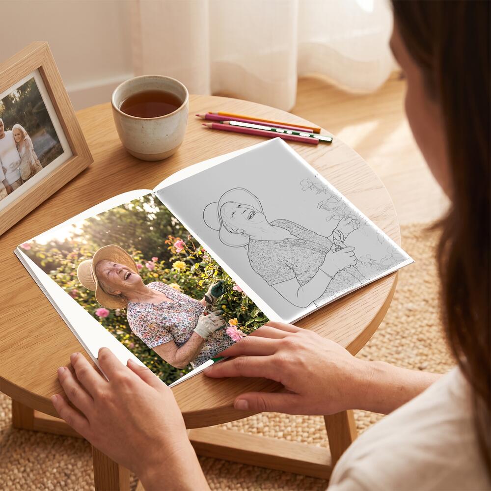 A photo on the left page and the same moment as a colouring page on the right.