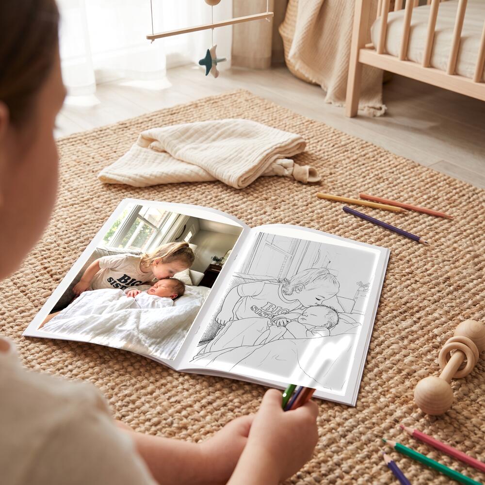 A photo on the left page and the same moment as a colouring page on the right.