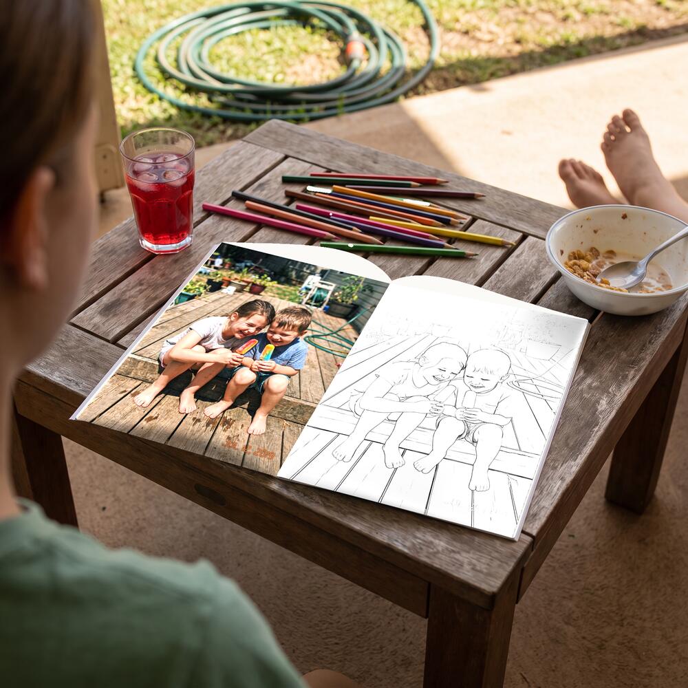 A photo on the left page and the same moment as a colouring page on the right.