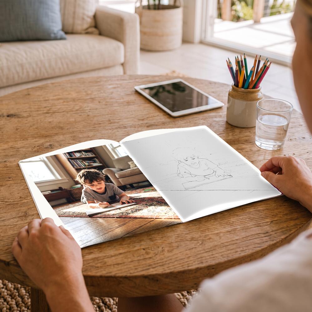 A photo on the left page and the same moment as a colouring page on the right.
